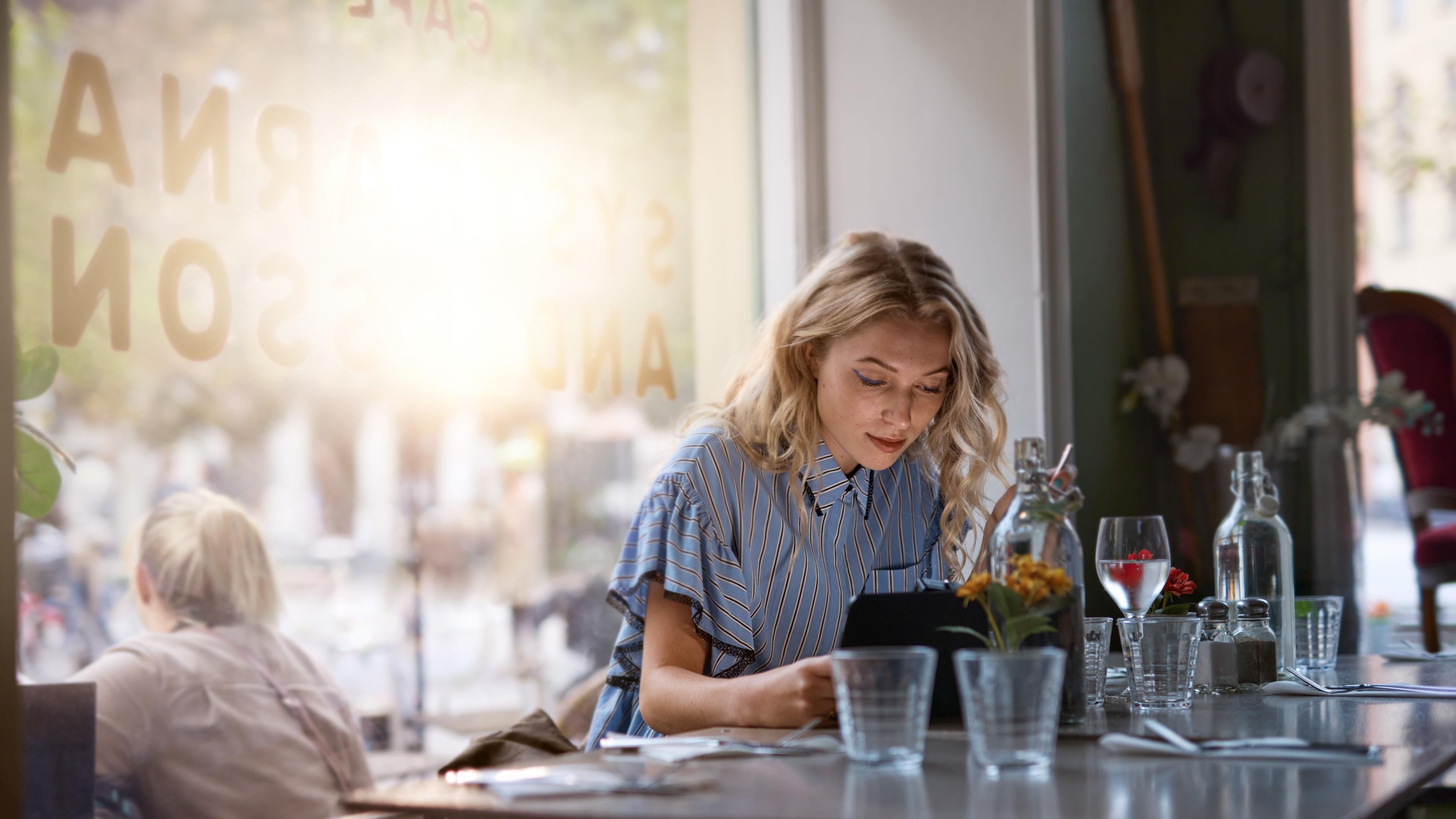 Kvinna arbetar vid restaurangdisk